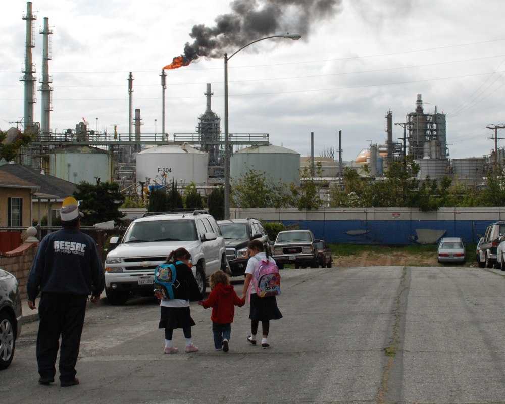 A photo shows the proximity of industrial activity to homes in Wilmington, Calif., near Los Angeles, where the Liberty Hill Foundation and  its partners are promoting local environmental-health and land-use policies that will reduce pollution and the health problems it causes.