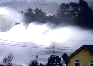 A storm surge crashes over coastal New Hampshire, one of the states where public officials are trying to prepare for the impacts of climate change.